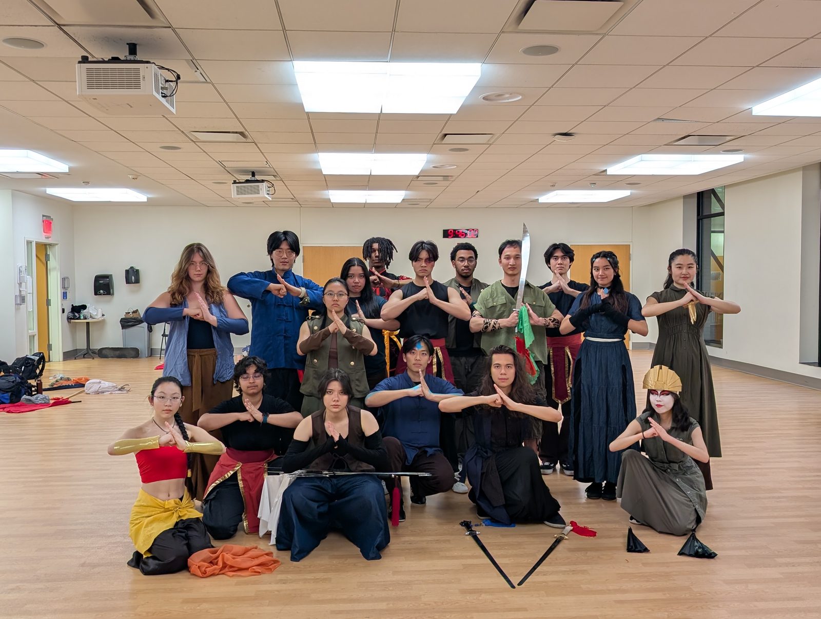 The club gathered in a rehearsal room, everyone holding the traditional wushu salute