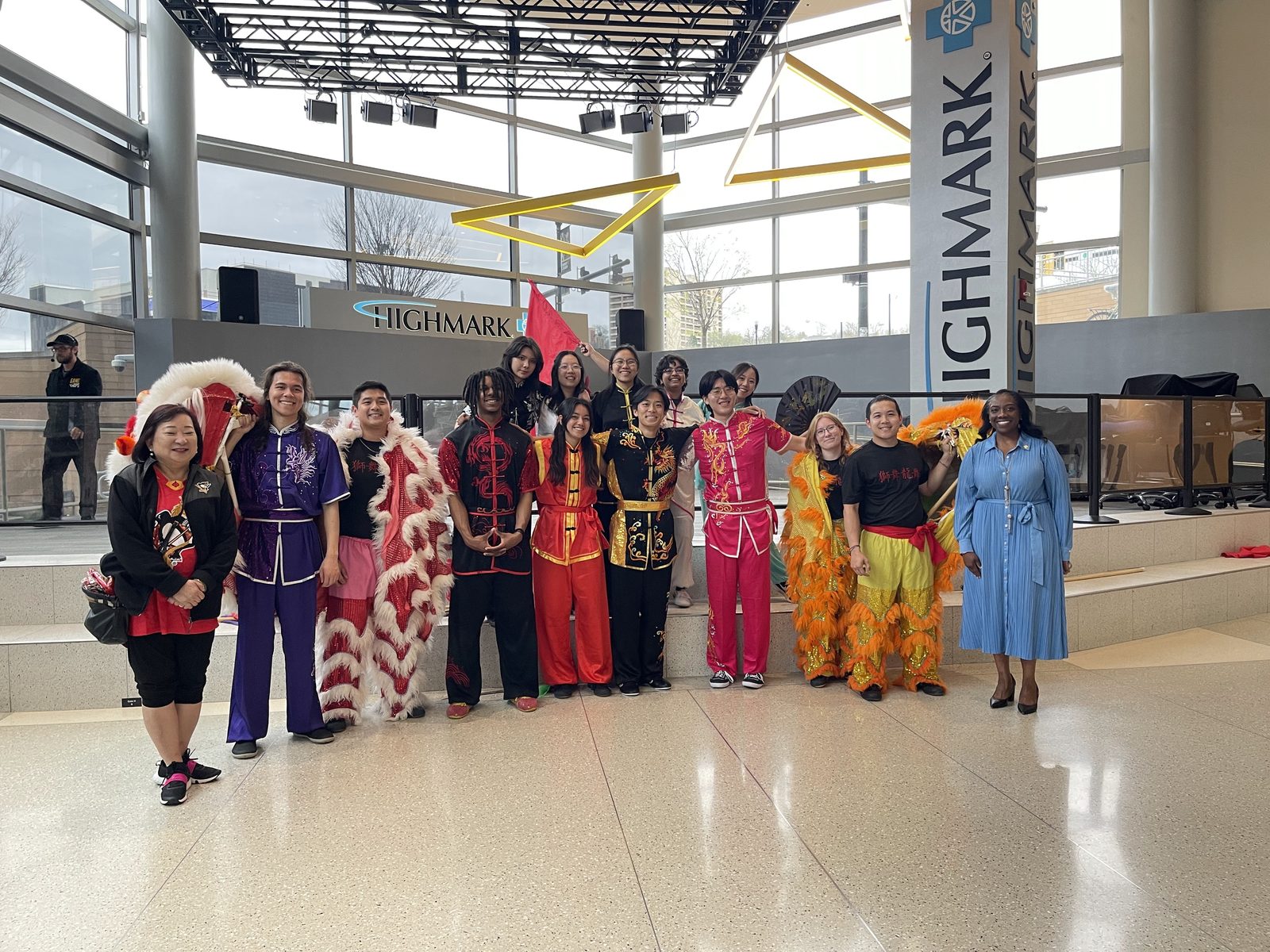 The club posing together with a lion dance costume in the arena concourse